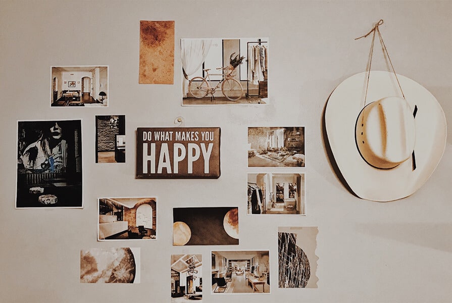 Decoração de parede com fotografias e quadros pendurados com um chapéu branco decoração afetiva