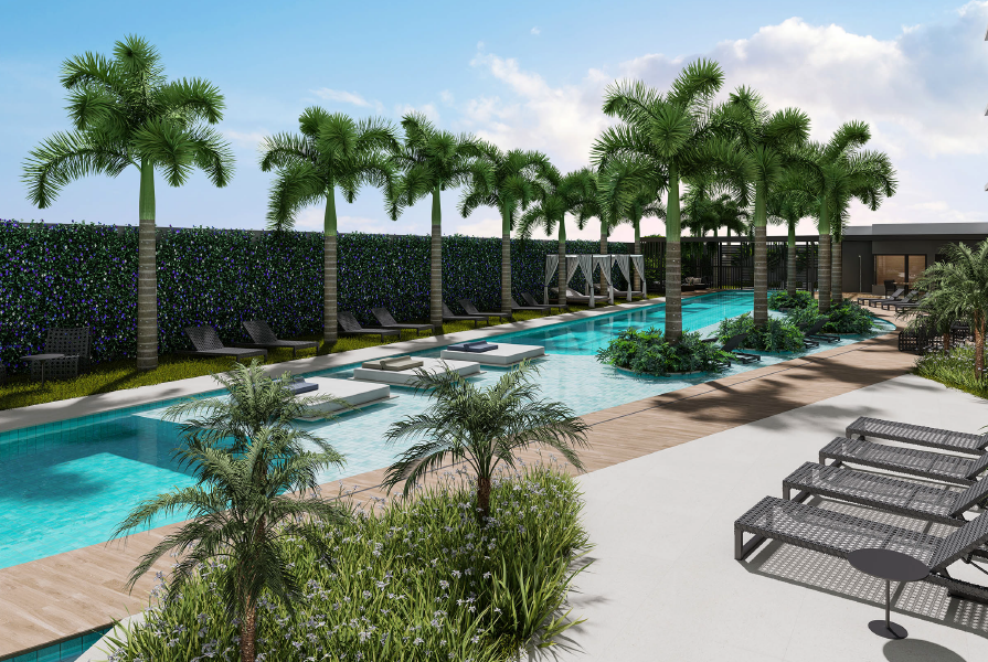 Área de lazer composta por uma piscina, espreguiçadeiras, diversas palmeiras e vegetações ao redor.