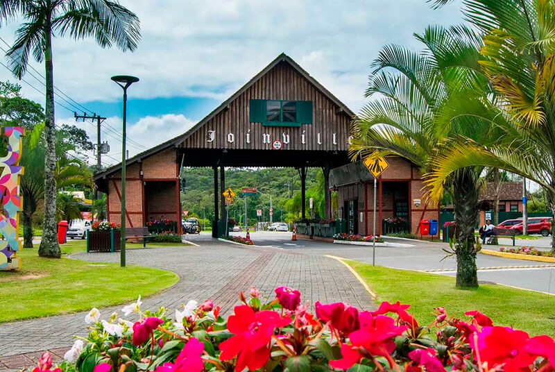Entrada da cidade de Joinville com flores coloridas.