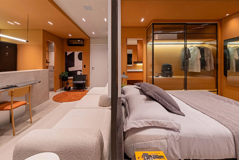 Ambiente moderno de quarto e sala em tons laranja